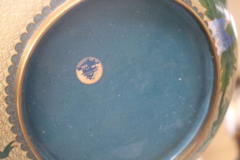 A Chinese cloisonne bowl and cover, decorated with flowers, on ebonised stand, diameter 26cm, overall height 21cm